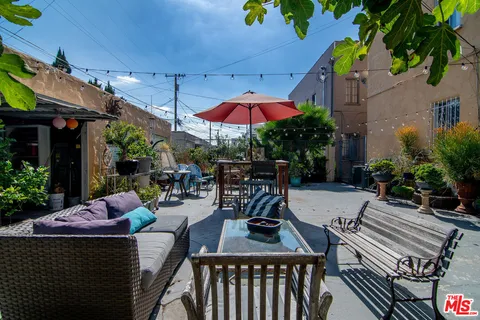 a view of a patio with a table and chairs under an umbrella