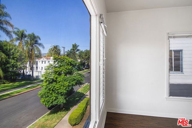 a view of a yard from a corridor