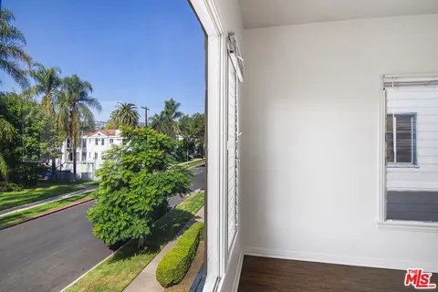 a view of a yard from a corridor