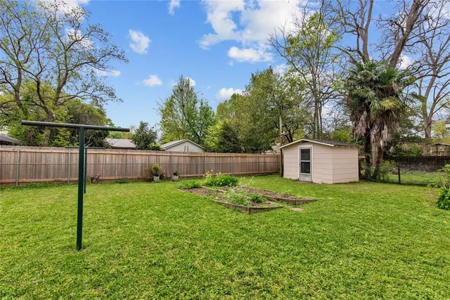 a house with a big yard and large trees