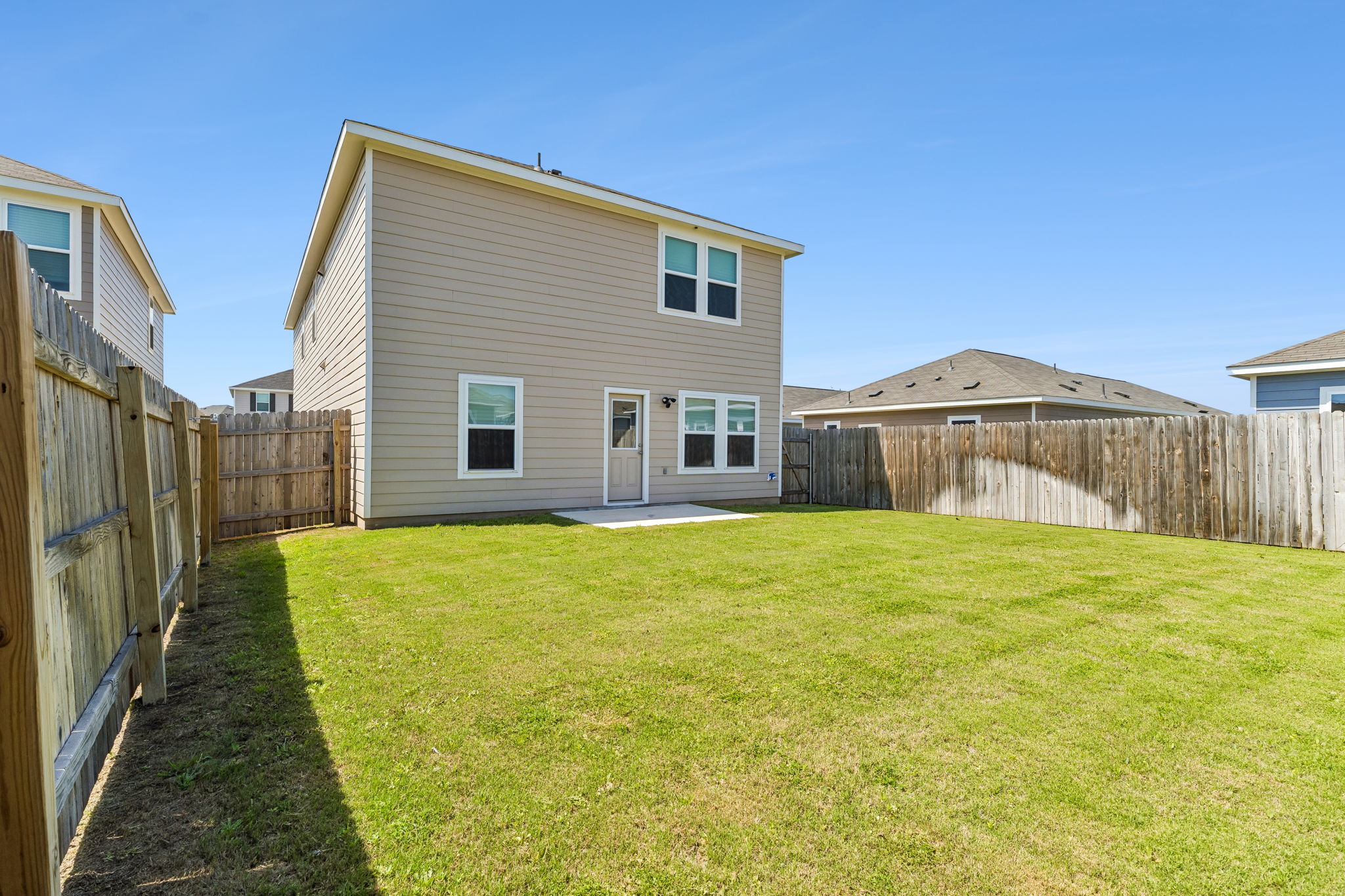 550 Thistle Lane Maxwell, TX 78656 - Photo 28 of 29 Back of property with a patio area and a fenced backyard