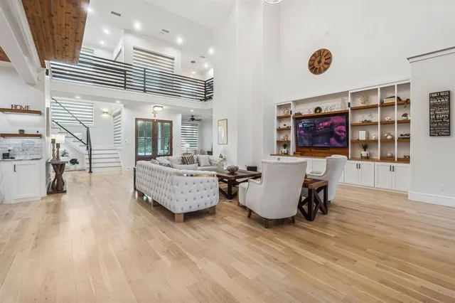 a living room with kitchen furniture and a wooden floor