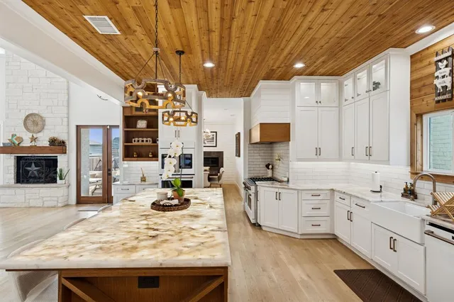 a kitchen with stainless steel appliances granite countertop a sink and cabinets