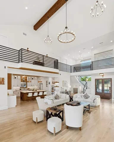 a living room with furniture a wooden floor and a chandelier