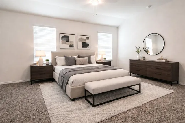 a bedroom with bed and a chandelier