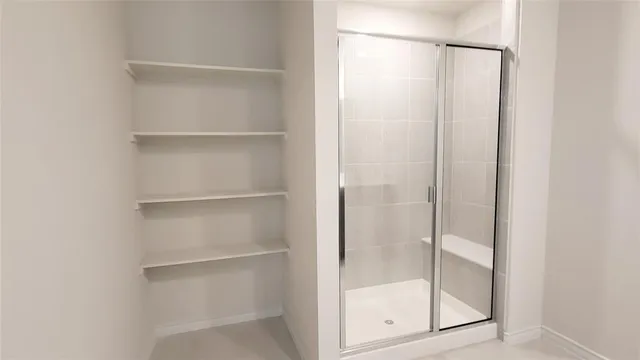a bathroom with a glass shower door