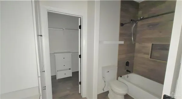 a bathroom with a granite countertop toilet sink and shower