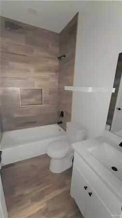 a bathroom with a sink a toilet and bathtub