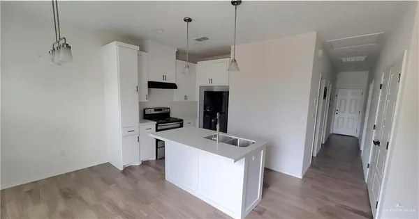 a kitchen with a refrigerator a sink and dishwasher