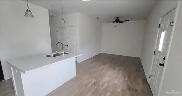 a view of a room with wooden floor