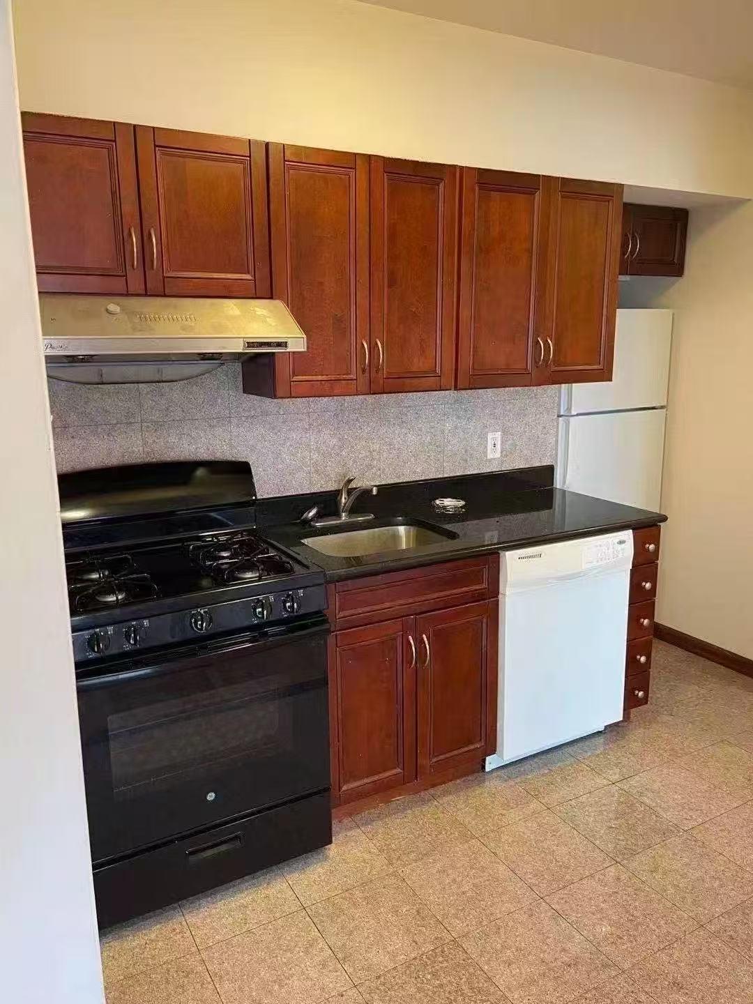 88-27 53rd Avenue, Unit 2R Queens, NY 11373 - Photo 2 of 6 Kitchen with white appliances, tasteful backsplash, exhaust hood, and dark countertops