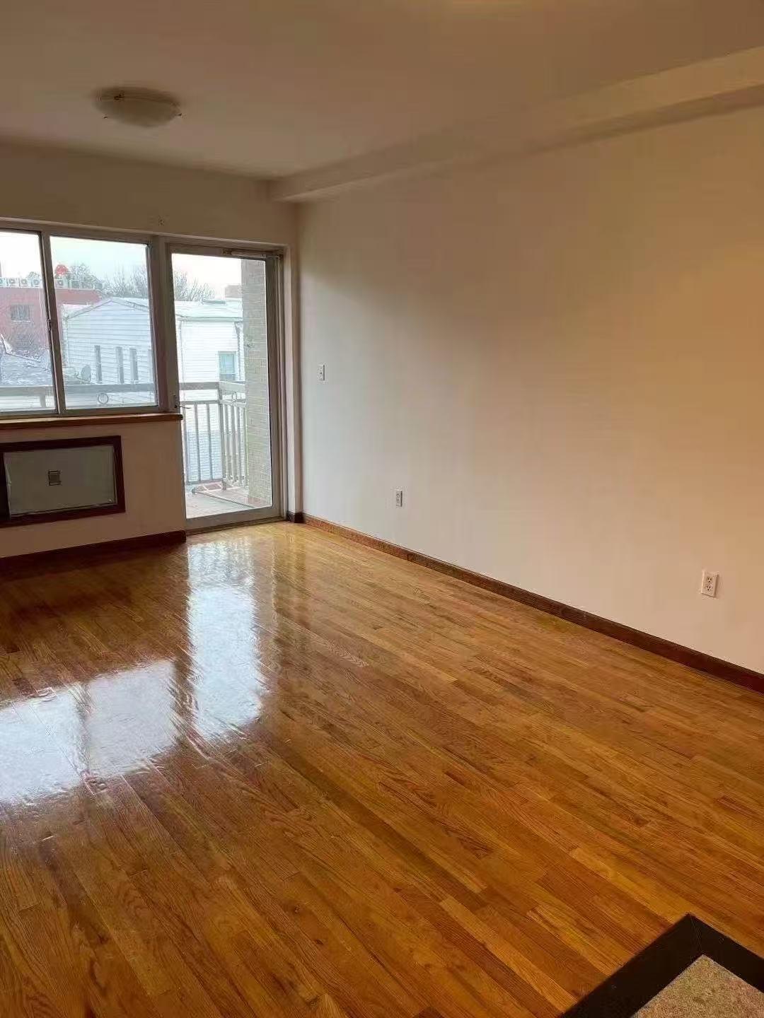88-27 53rd Avenue, Unit 2R Queens, NY 11373 - Photo 4 of 6 Unfurnished room featuring wood finished floors and baseboards