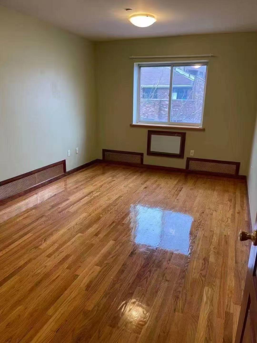 88-27 53rd Avenue, Unit 2R Queens, NY 11373 - Photo 5 of 6 Empty room with wood finished floors and baseboards
