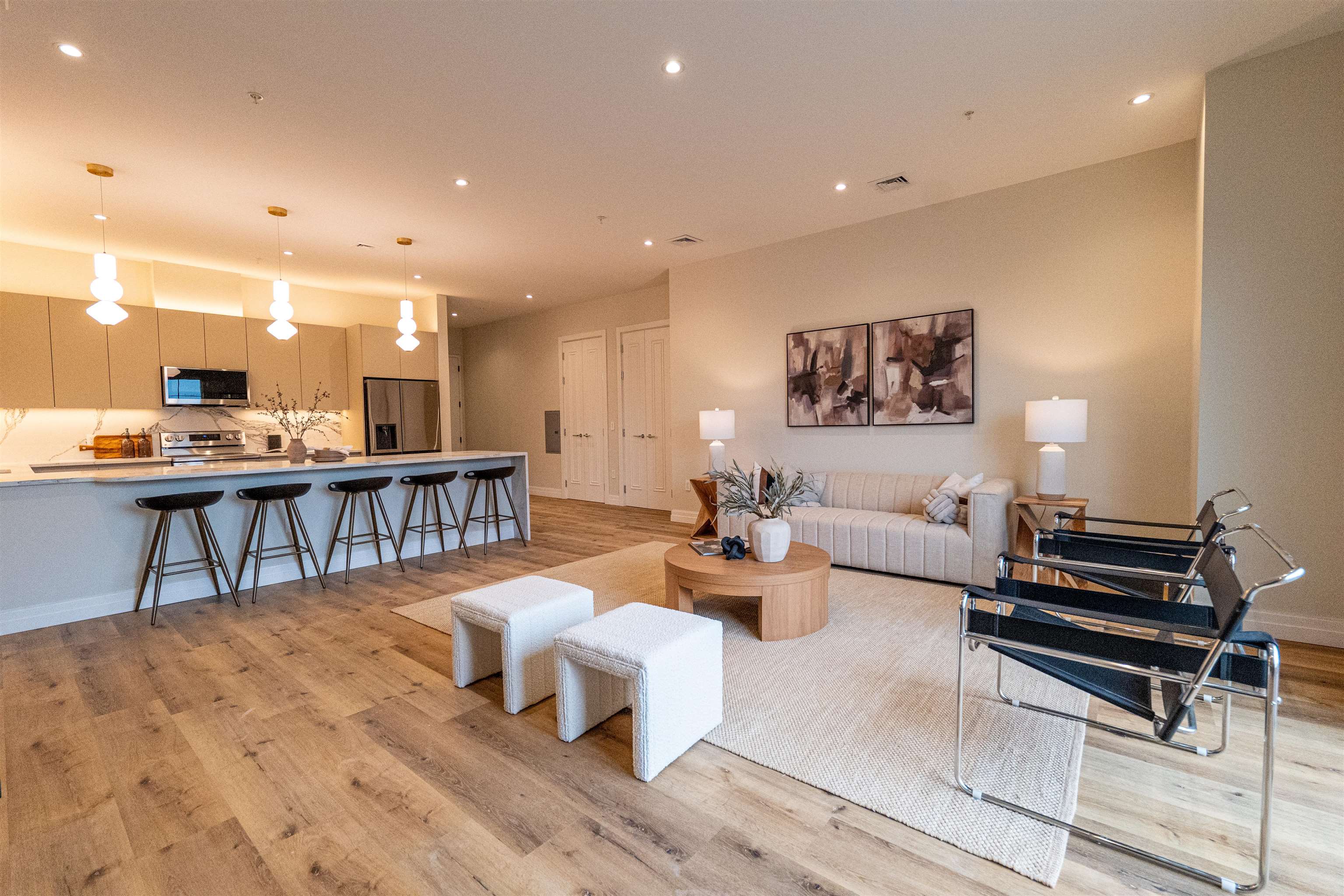 a living room with lots of furniture and a wooden floor