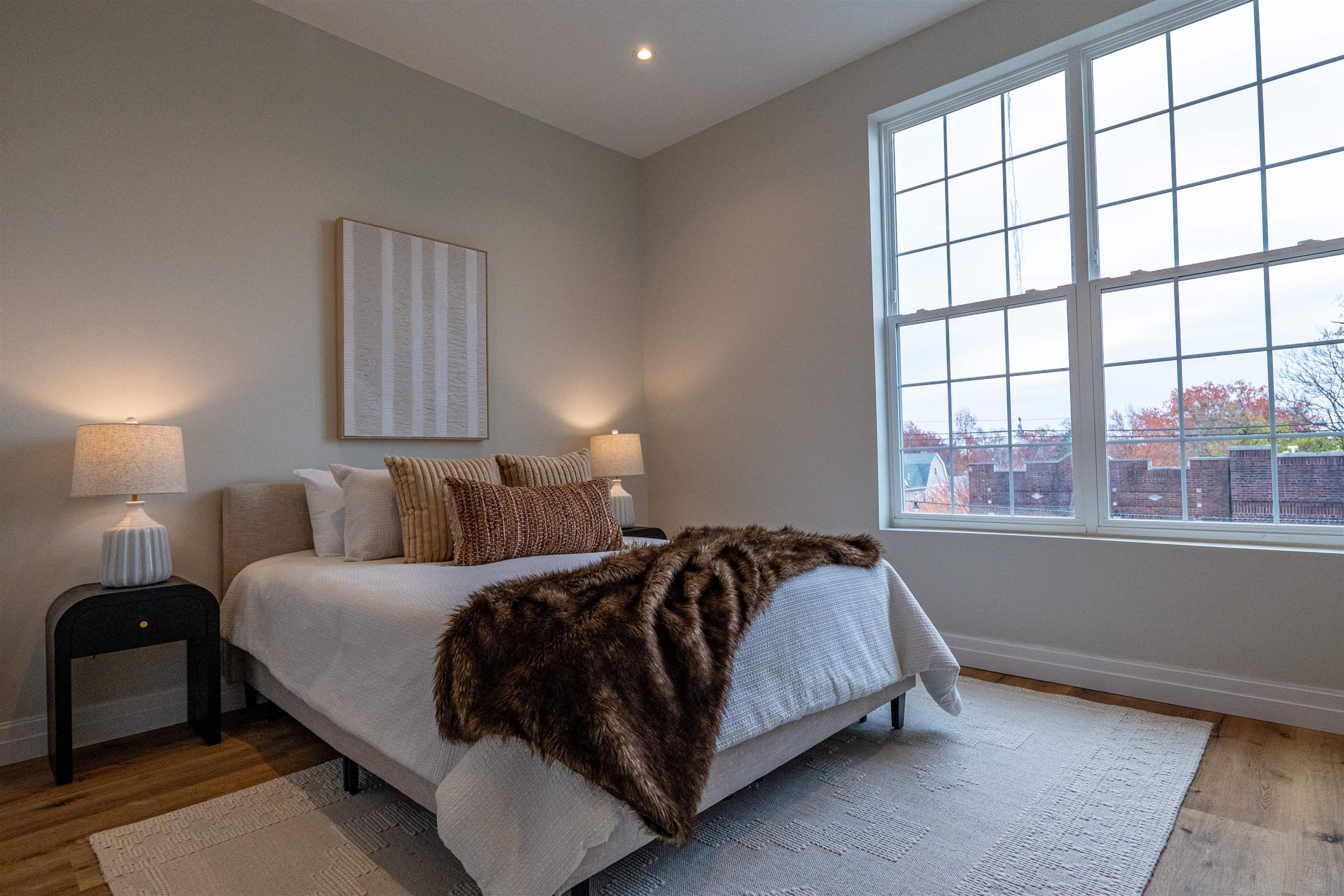 1722 Springfield Avenue, Unit 302 Maplewood, NJ 07040 - Photo 12 of 31 a bedroom with a bed and a large window