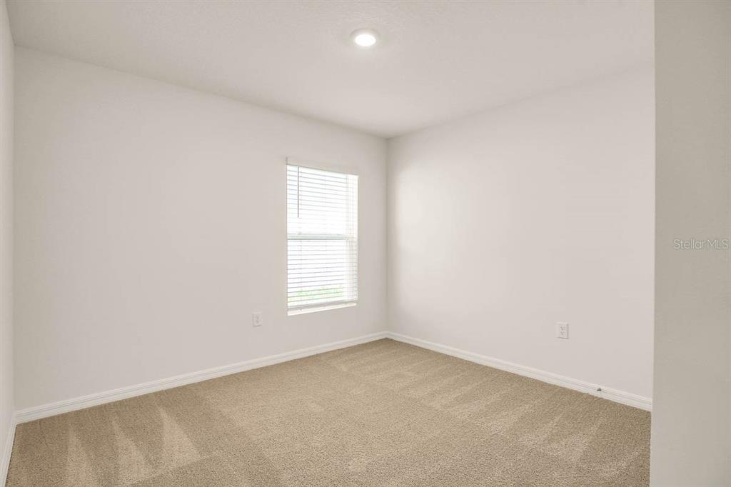 16530 Windmill Forge Pass Wimauma, FL 33598 - Photo 17 of 33 an empty room with a window