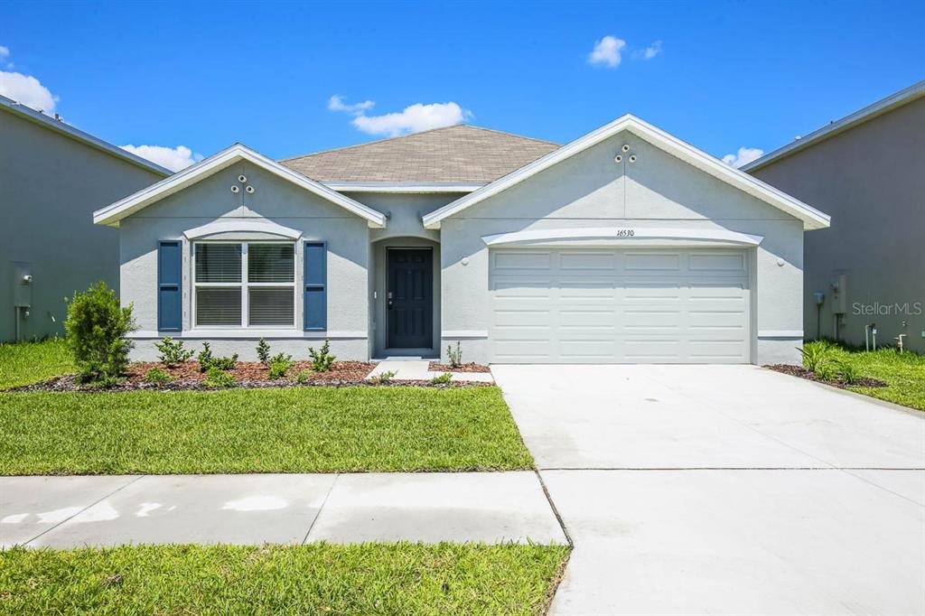 16530 Windmill Forge Pass Wimauma, FL 33598 - Photo 26 of 33 a front view of a house with a yard