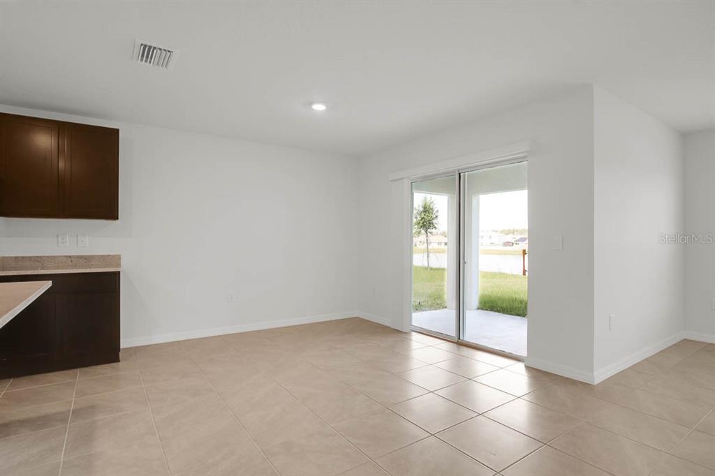 16530 Windmill Forge Pass Wimauma, FL 33598 - Photo 10 of 33 a view of an empty room with a fireplace