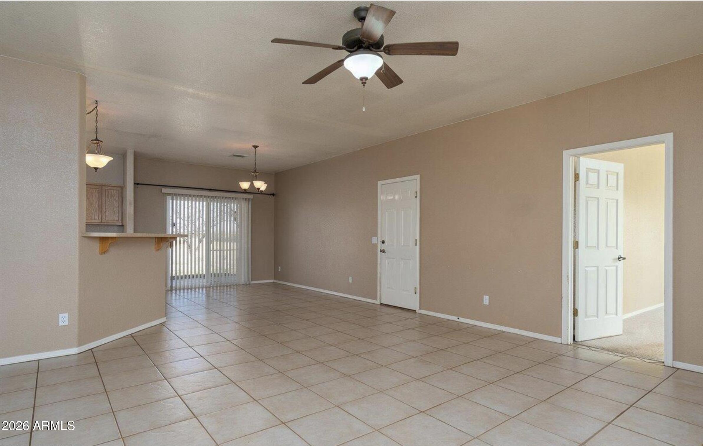 10193 East Windtalker Road Hereford, AZ 85615 - Photo 2 of 34 a view of a livingroom with a ceiling fan and window