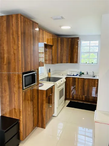 a kitchen with stainless steel appliances a stove a sink and a microwave