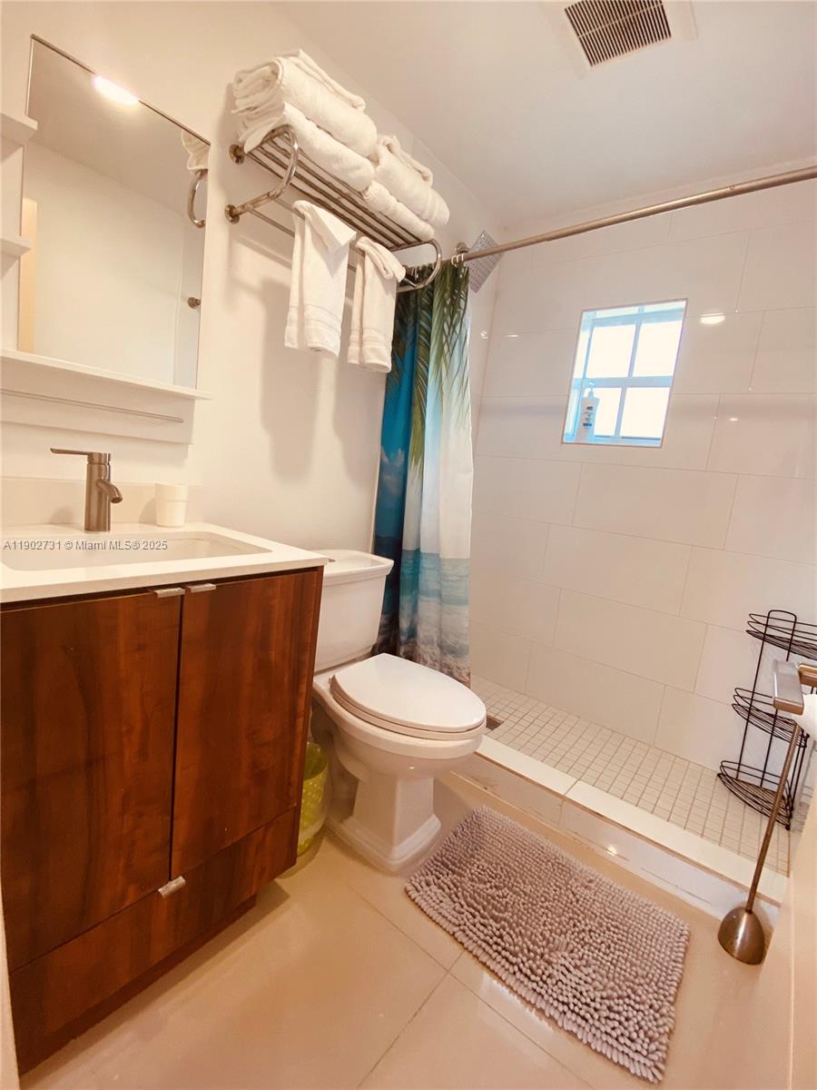 227 Northwest 34th Street, Unit 3 Miami, FL 33127 - Photo 6 of 6 a bathroom with a sink a toilet and shower