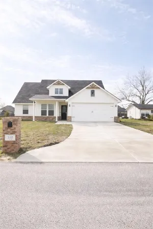 a house with swimming pool in front of it