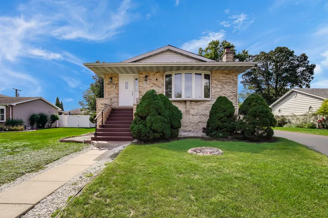 a front view of a house with a garden