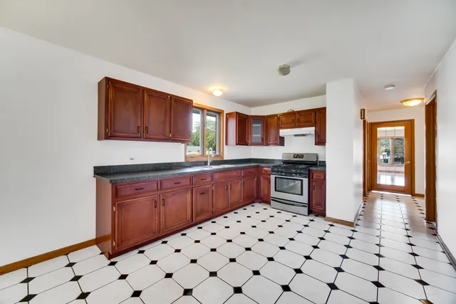 a kitchen with stainless steel appliances a sink and a refrigerator