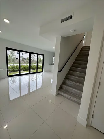 a view of a hallway with staircase