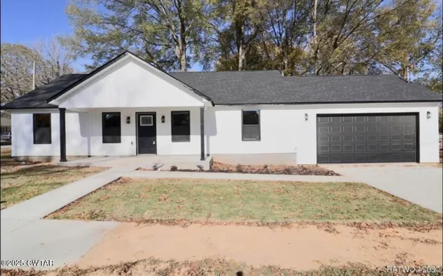 a house that has a tree in front of it