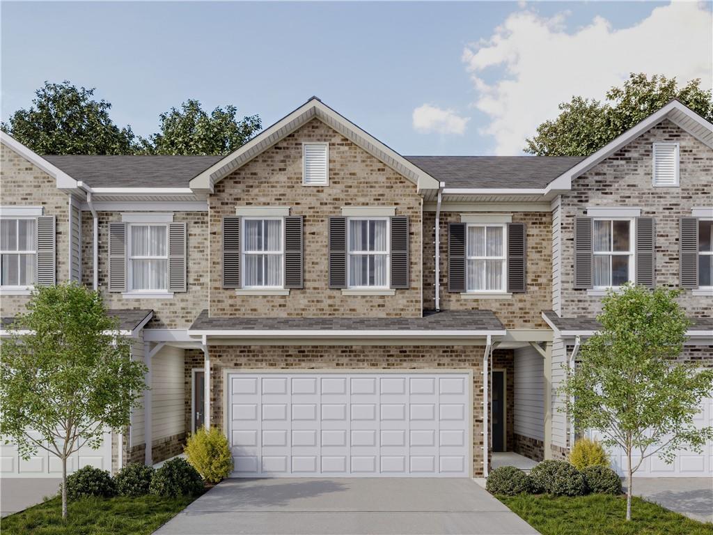 2206 Chant Street Dacula, GA 30019 - Photo 1 of 1 a front view of a house with a garden