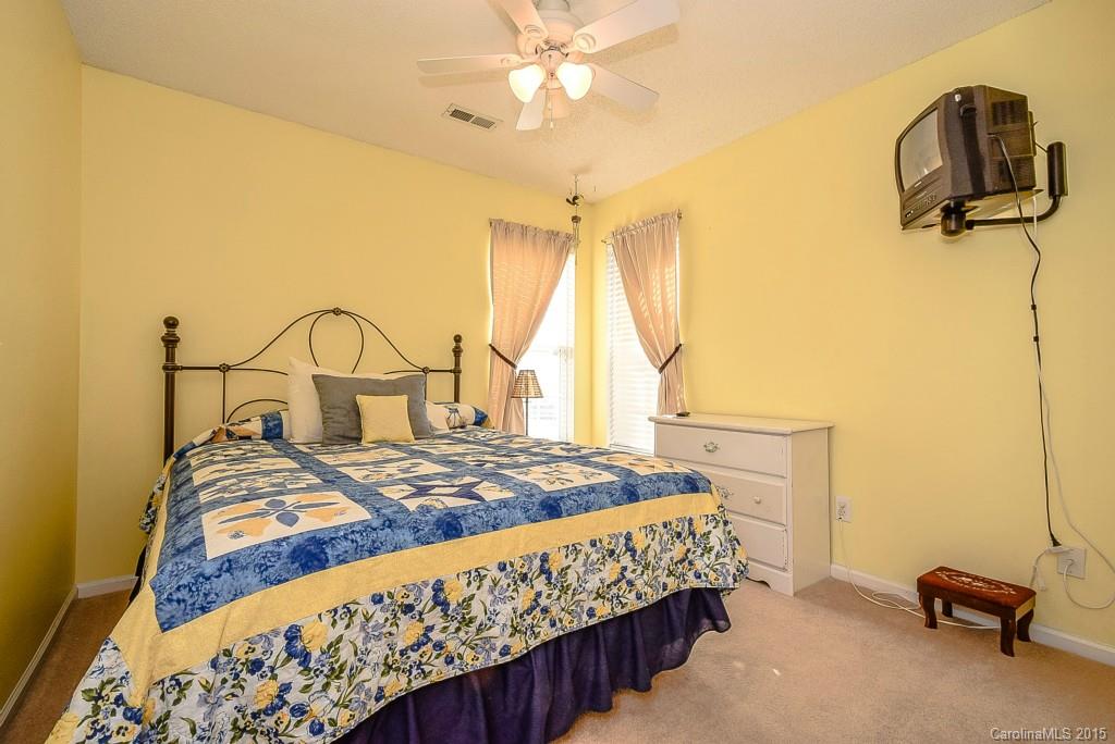 4004 Lake Park Road Indian Trail, NC 28079 - Photo 13 of 19 a bedroom with a bed and a chandelier