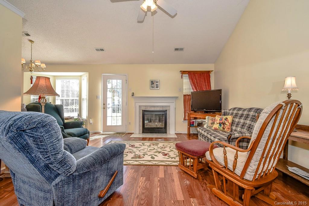 4004 Lake Park Road Indian Trail, NC 28079 - Photo 3 of 19 a living room with furniture a flat screen tv and a fireplace