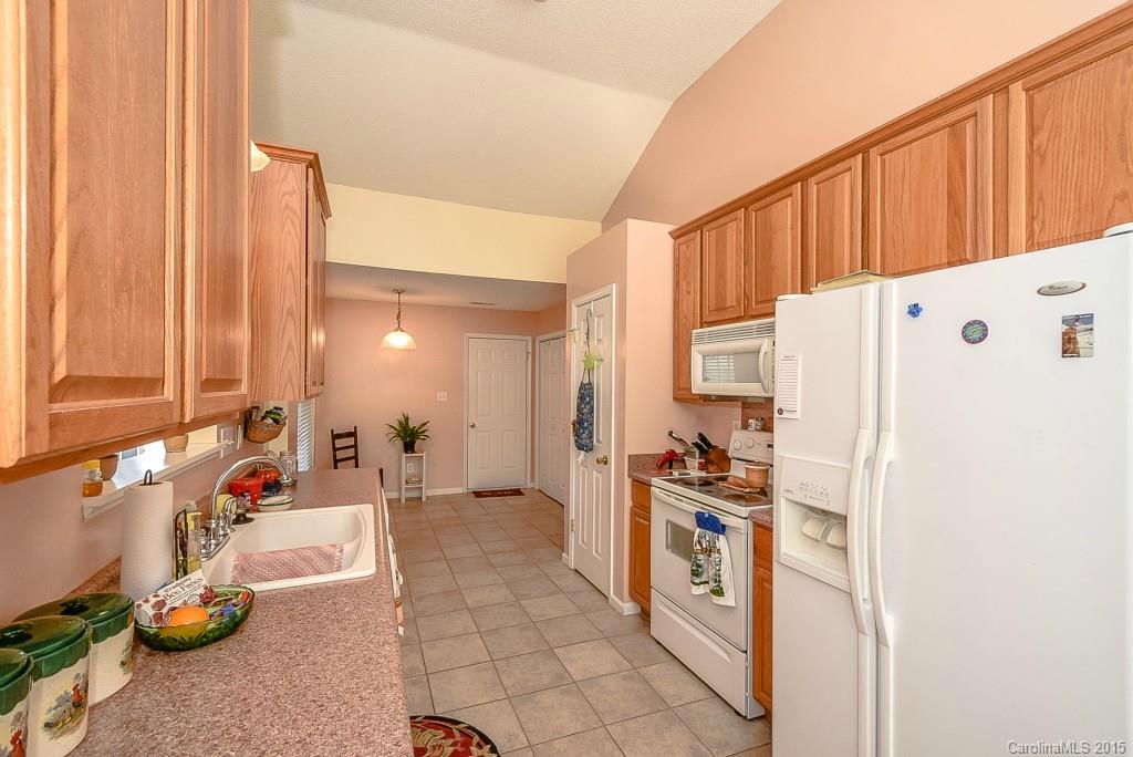 4004 Lake Park Road Indian Trail, NC 28079 - Photo 8 of 19 a kitchen with a refrigerator a stove and a wooden cabinets