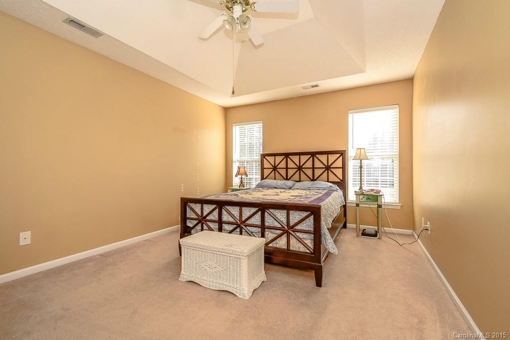 4004 Lake Park Road Indian Trail, NC 28079 - Photo 10 of 19 a bedroom with a bed and a chandelier