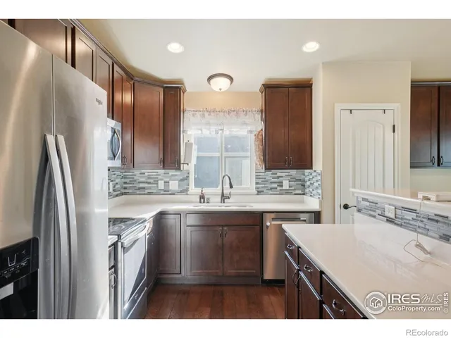 a kitchen with kitchen island a sink appliances and cabinets