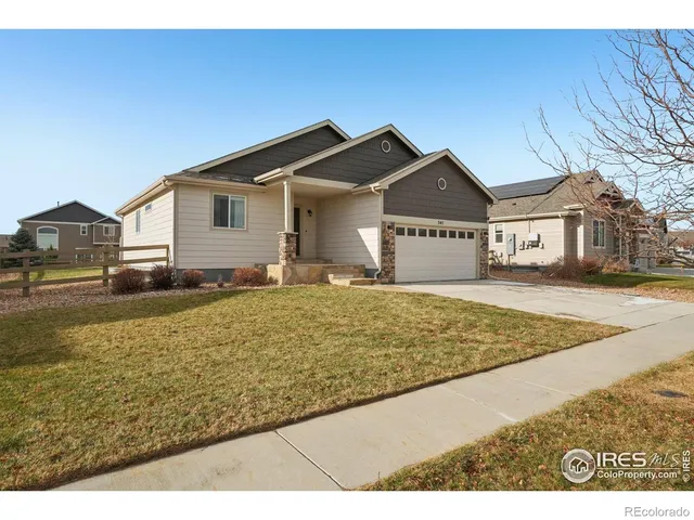 a view of a house with a yard and sitting area