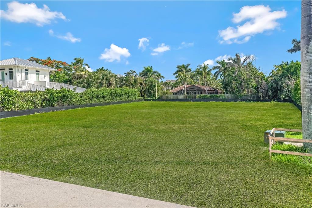 350 Rudder Road Naples, FL 34102 - Photo 2 of 14 a view of a big yard with an outdoor space and seating