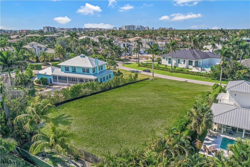 350 Rudder Road Naples, FL 34102 - Photo 4 of 14 a view of a house with a yard and a pool
