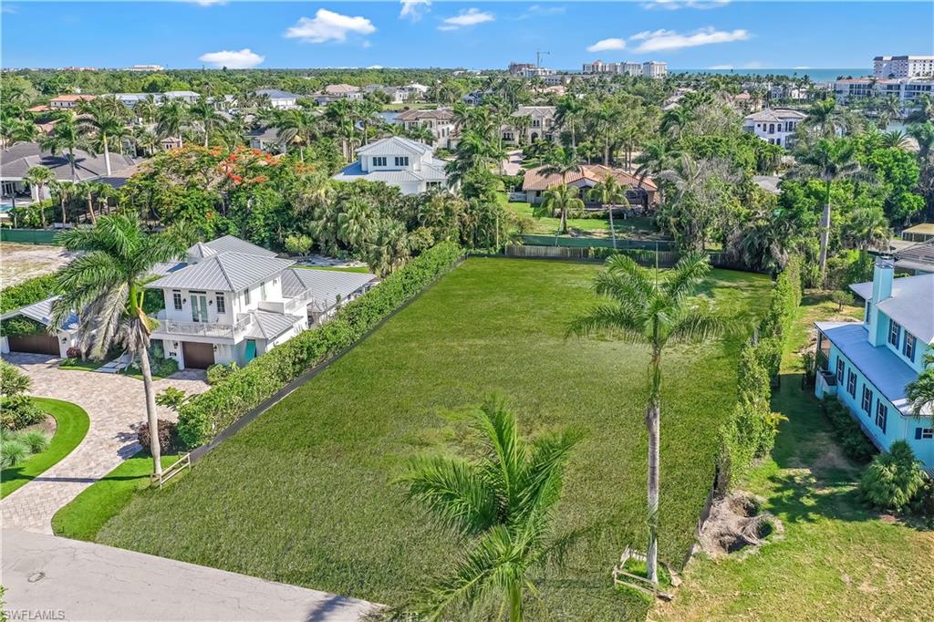 350 Rudder Road Naples, FL 34102 - Photo 6 of 14 an aerial view of a house with a garden and mountain view