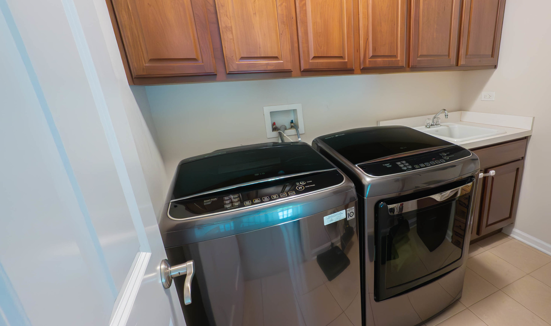 421 Post Oak Circle West Chicago, IL 60185 - Photo 17 of 22 a kitchen with a stove and white cabinets