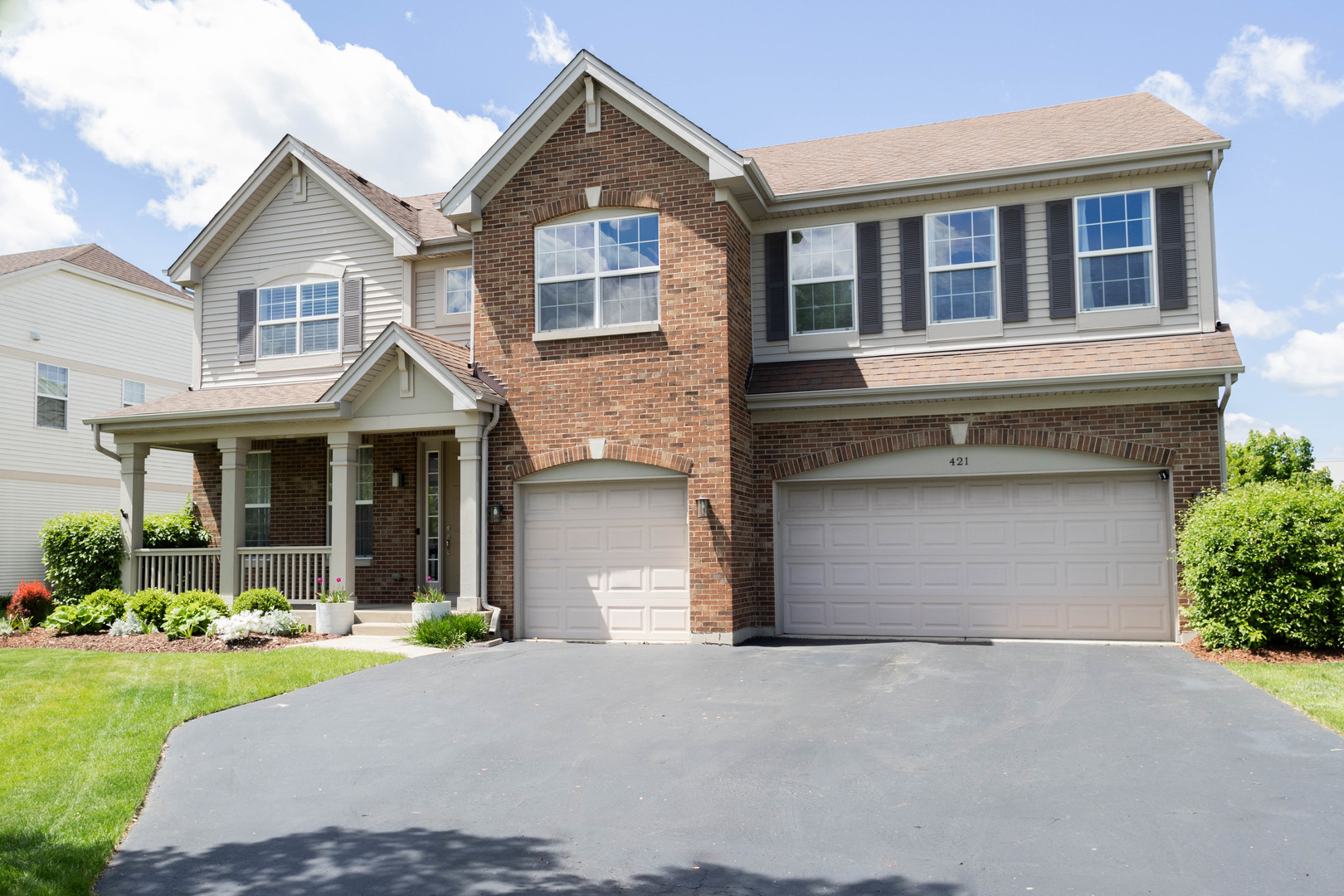 421 Post Oak Circle West Chicago, IL 60185 - Photo 2 of 22 a front view of a house with a yard and garage