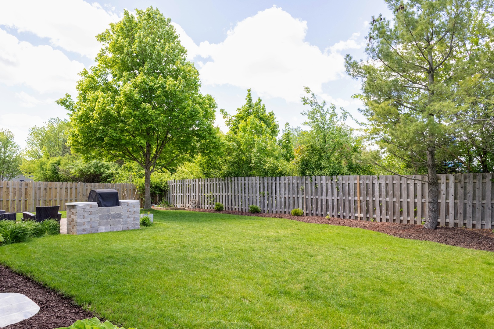 421 Post Oak Circle West Chicago, IL 60185 - Photo 21 of 22 a view of a backyard with a garden and deck