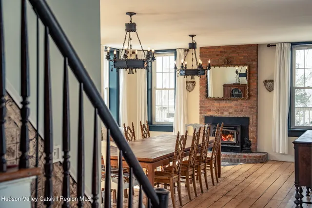a view of a livingroom with furniture staircase and fireplace