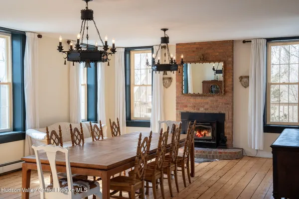 a dining room with furniture window and wooden floor