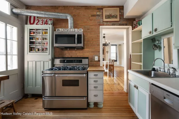a kitchen with stainless steel appliances a stove and a sink