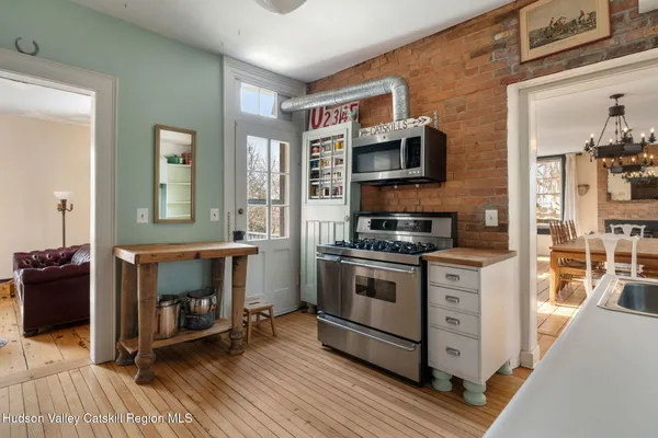 a kitchen with stainless steel appliances granite countertop a stove and a refrigerator