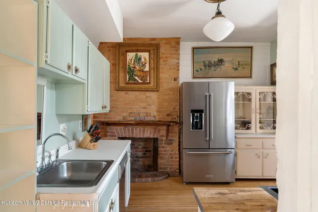a kitchen with stainless steel appliances a refrigerator sink and cabinets