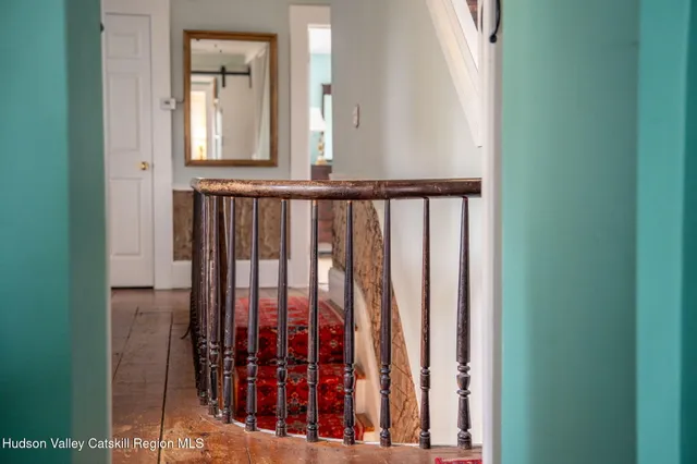 a view of a hallway with windows and stairs