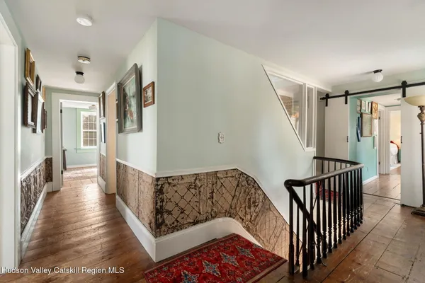 a bedroom with a bed couches and window